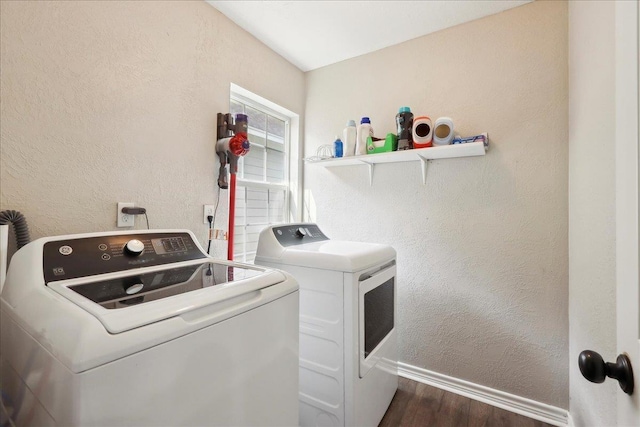 laundry area featuring washing machine and clothes dryer and dark hardwood / wood-style floors