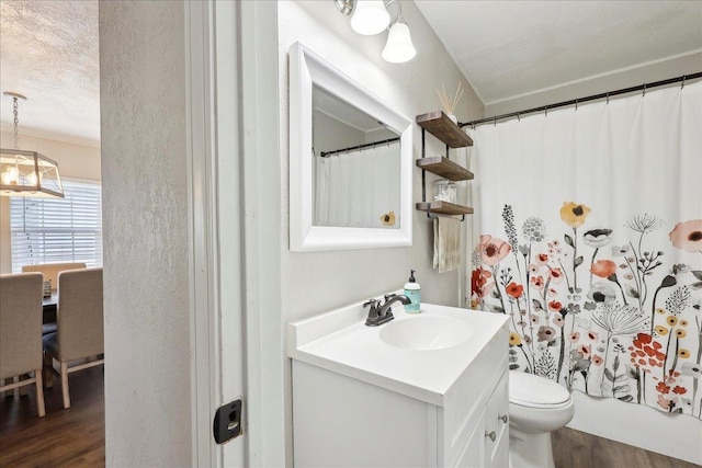 full bathroom featuring vanity, hardwood / wood-style floors, shower / bath combo, and toilet