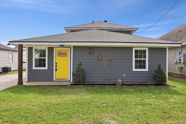 back of property featuring a yard and central air condition unit