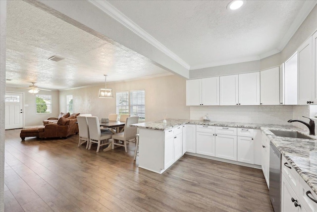 kitchen featuring white cabinetry, wood-type flooring, sink, and kitchen peninsula