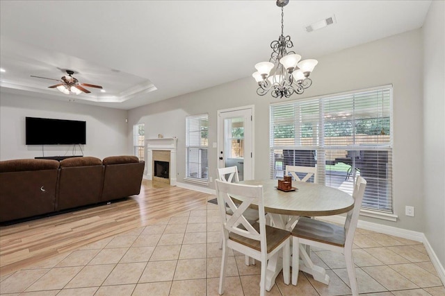 7820 N Windemere Dr, Beaumont, TX 77713 - dining area featuring a chandelier, light tile patterned flooring, a fireplace, and baseboards