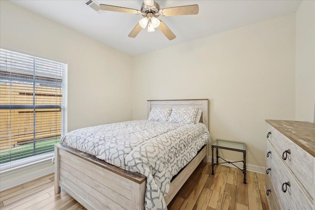 7820 N Windemere Dr, Beaumont, TX 77713 - bedroom with multiple windows, light wood finished floors, baseboards, and ceiling fan