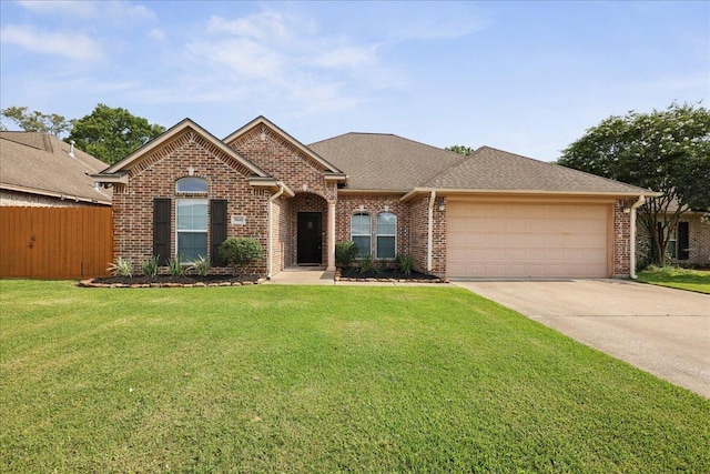 7820 N Windemere Dr, Beaumont, TX 77713 - view of front of house with an attached garage, brick siding, driveway, and roof with shingles