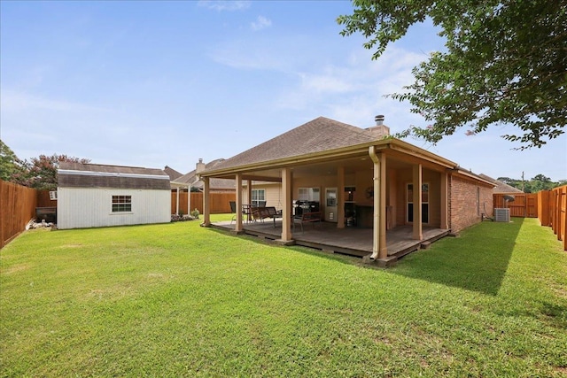 7820 N Windemere Dr, Beaumont, TX 77713 - back of property with a chimney, central AC unit, an outbuilding, and a wooden deck