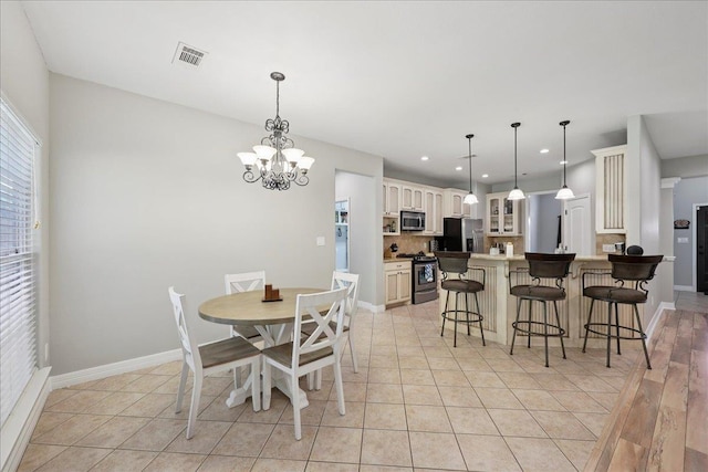 7820 N Windemere Dr, Beaumont, TX 77713 - dining area featuring a chandelier, light tile patterned flooring, baseboards, and recessed lighting