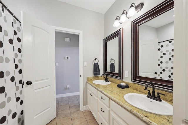 7820 N Windemere Dr, Beaumont, TX 77713 - bathroom featuring double vanity, baseboards, and curtained shower