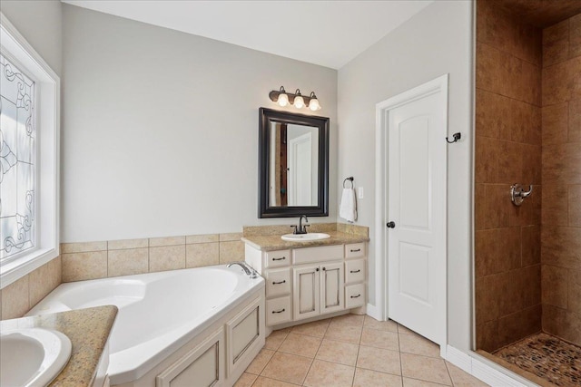 7820 N Windemere Dr, Beaumont, TX 77713 - bathroom featuring vanity, a garden tub, tile patterned floors, and a tile shower
