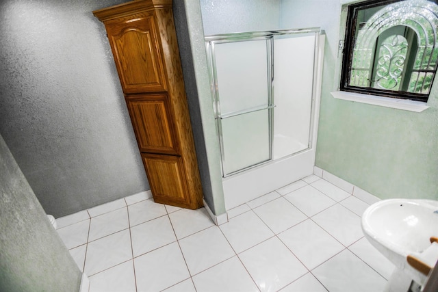 bathroom with tile patterned floors and enclosed tub / shower combo