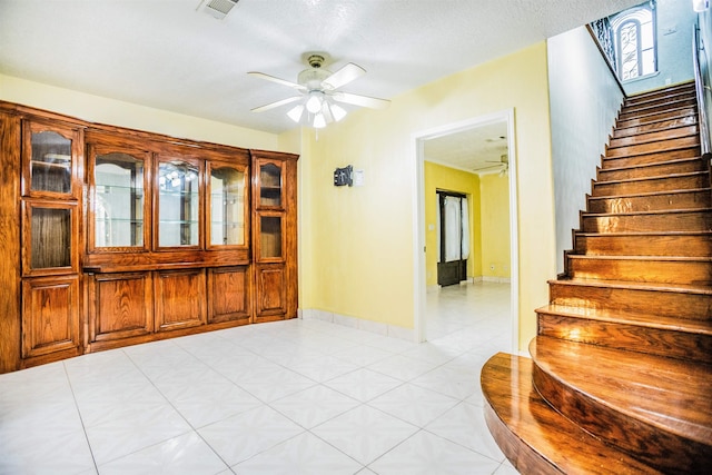 tiled entrance foyer with ceiling fan