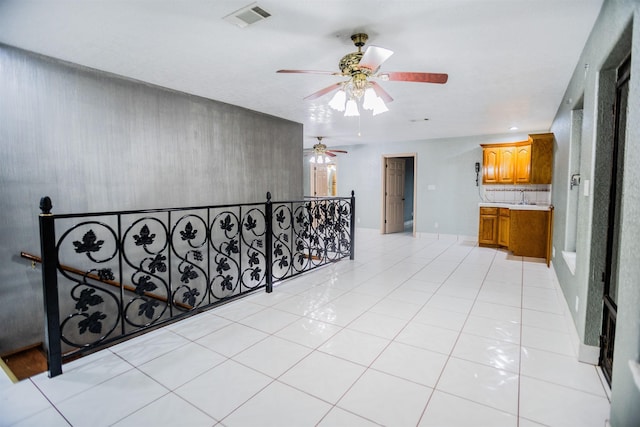 hall with sink and light tile patterned floors