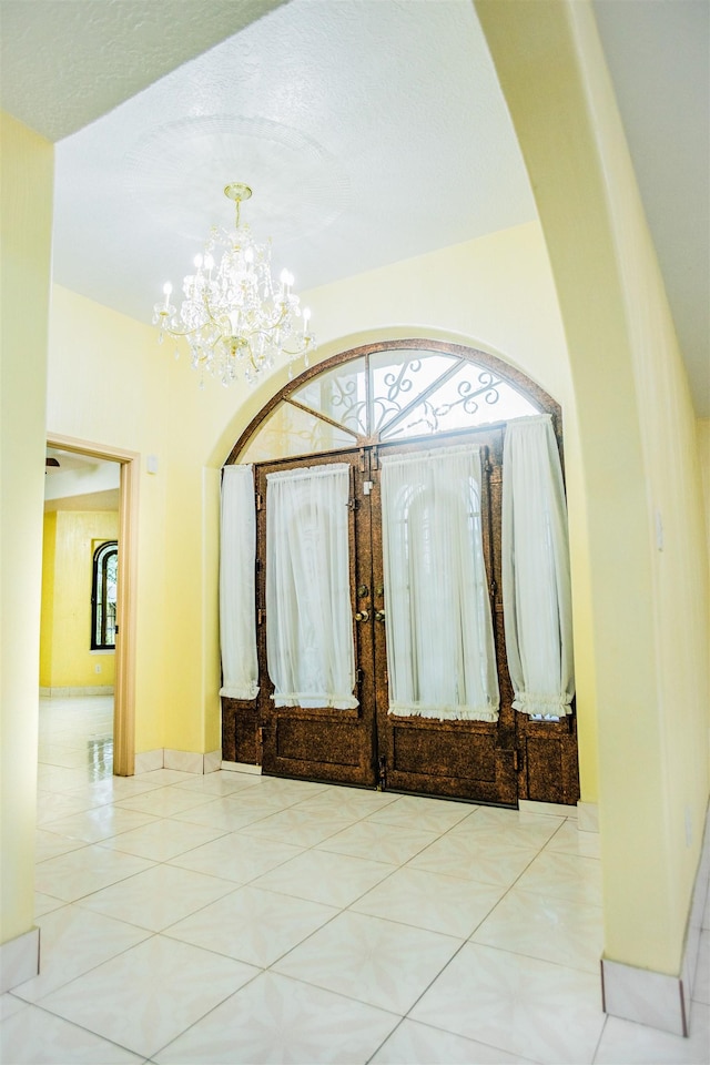 entrance foyer with an inviting chandelier and light tile patterned flooring