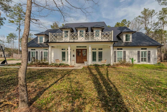 view of front of house with french doors, a balcony, a porch, and a front lawn