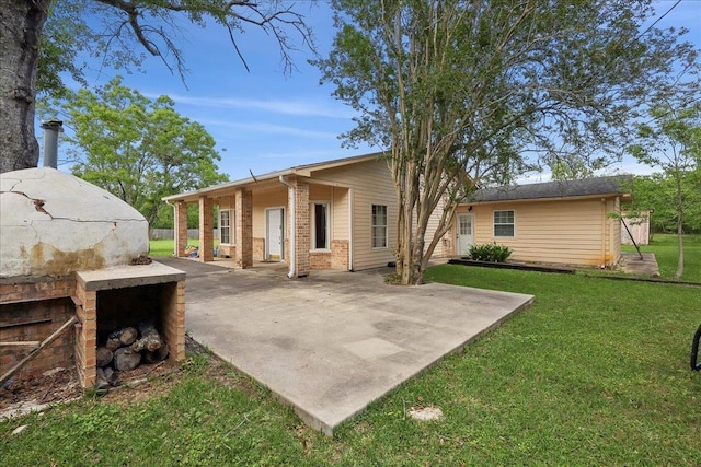 1035 Chamberlin Dr, Beaumont, TX 77707 - rear view of house featuring brick siding, a patio area, and a lawn