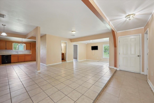 1035 Chamberlin Dr, Beaumont, TX 77707 - unfurnished living room with a sink, light tile patterned flooring, visible vents, and baseboards