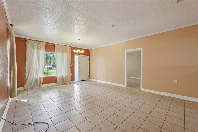 1035 Chamberlin Dr, Beaumont, TX 77707 - unfurnished room with an inviting chandelier, a textured ceiling, crown molding, and light tile patterned floors