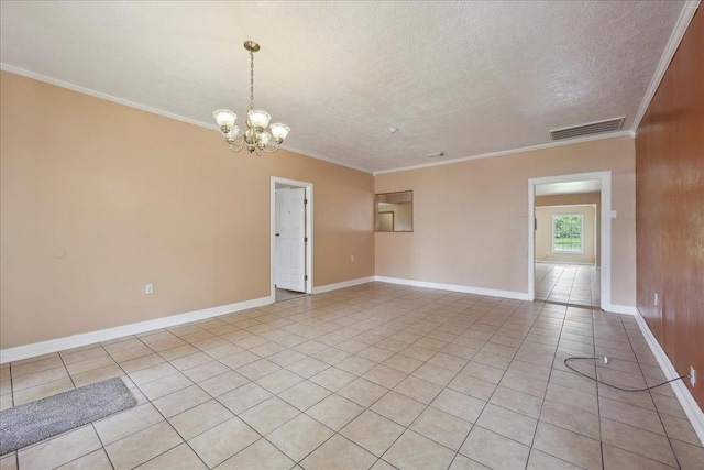 1035 Chamberlin Dr, Beaumont, TX 77707 - unfurnished room featuring light tile patterned floors, a textured ceiling, crown molding, visible vents, and an inviting chandelier