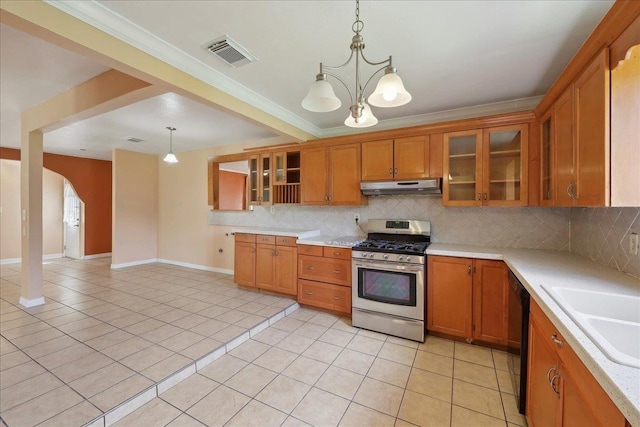1035 Chamberlin Dr, Beaumont, TX 77707 - kitchen with visible vents, brown cabinets, under cabinet range hood, and stainless steel range with gas stovetop