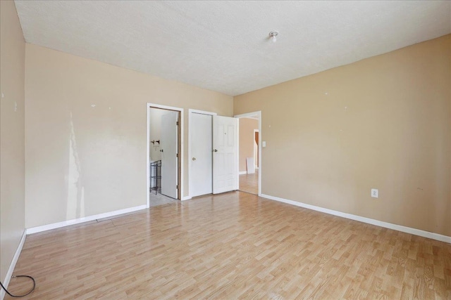 1035 Chamberlin Dr, Beaumont, TX 77707 - unfurnished bedroom with wood finished floors and baseboards