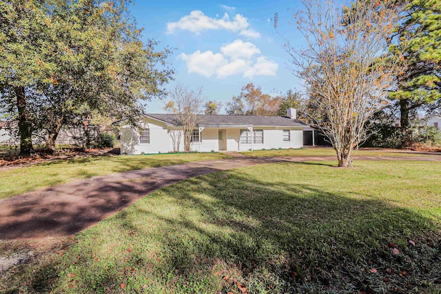 ranch-style home with a front lawn