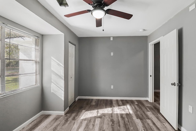 spare room featuring hardwood / wood-style flooring and ceiling fan