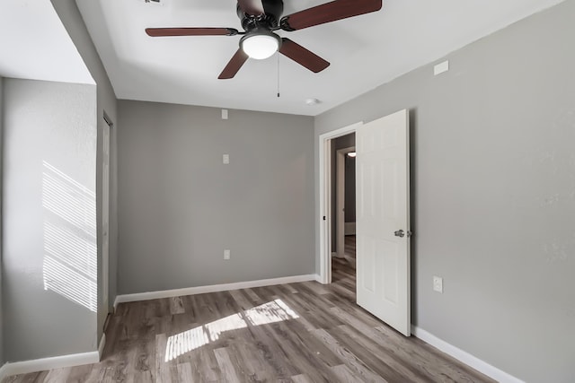 spare room with light hardwood / wood-style floors and ceiling fan