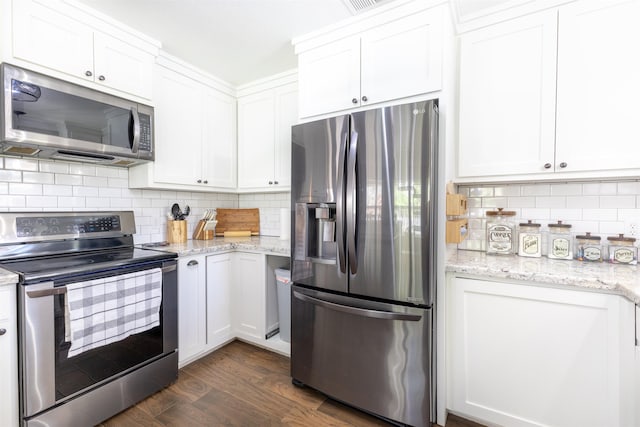 310 Medford Ln, Vidor, TX 77662 - kitchen featuring white cabinets, appliances with stainless steel finishes, and dark wood finished floors