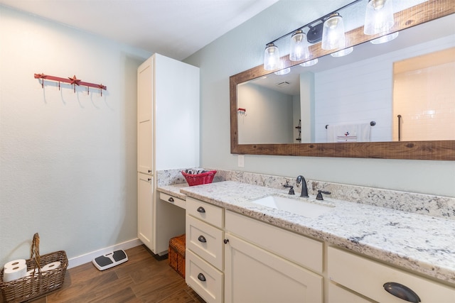 310 Medford Ln, Vidor, TX 77662 - bathroom featuring vanity, baseboards, visible vents, and wood finished floors