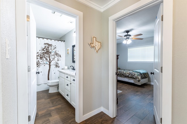 310 Medford Ln, Vidor, TX 77662 - corridor with dark wood-style floors, visible vents, ornamental molding, and baseboards