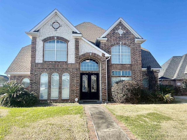 french provincial home with a front yard