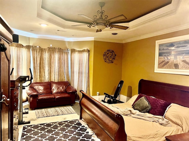 bedroom with ceiling fan, ornamental molding, and a tray ceiling