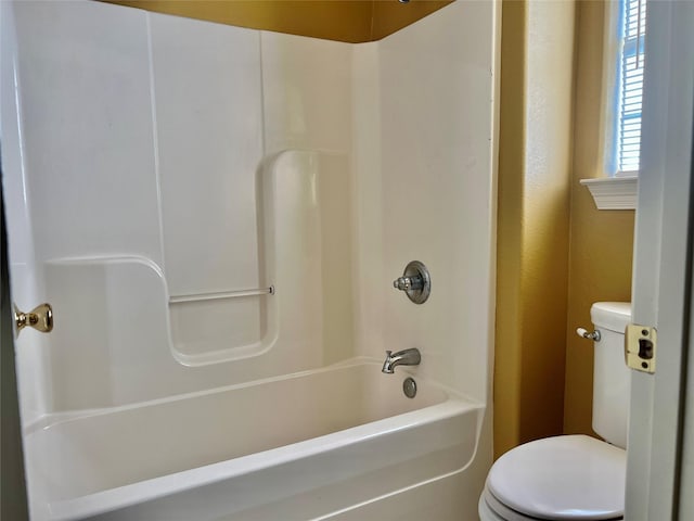 bathroom with shower / bathing tub combination and toilet