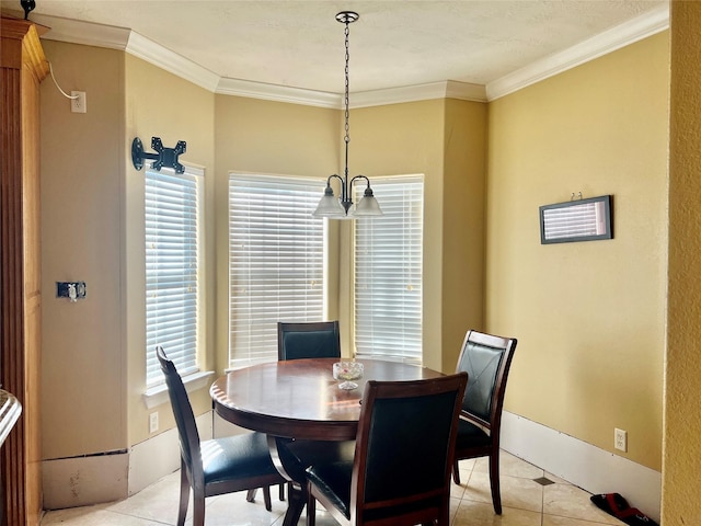 dining area featuring light tile patterned floors, ornamental molding, and a notable chandelier