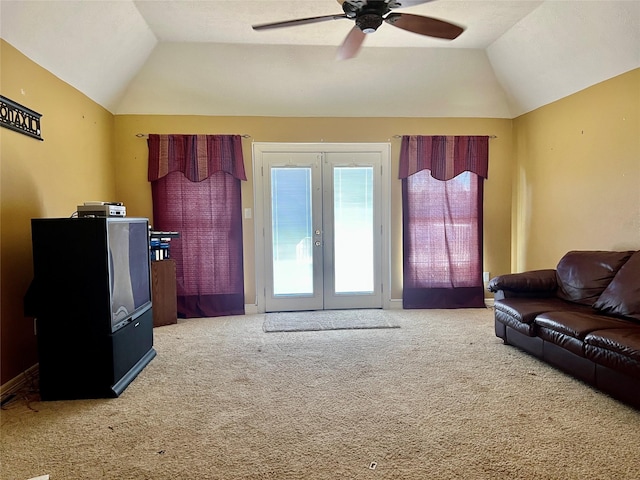 carpeted living room with french doors, vaulted ceiling, and ceiling fan