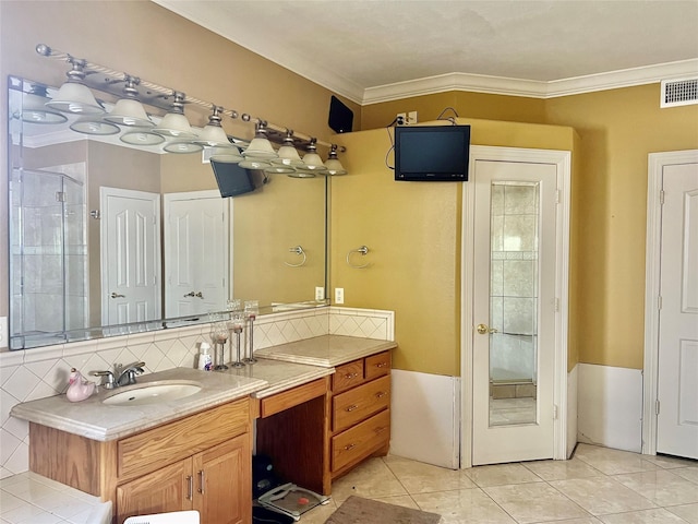 bathroom with tile patterned flooring, vanity, decorative backsplash, and ornamental molding