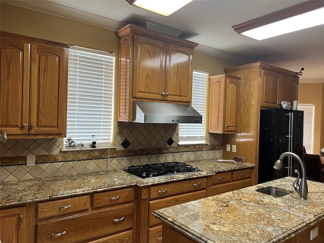 kitchen featuring decorative backsplash, extractor fan, crown molding, sink, and black appliances