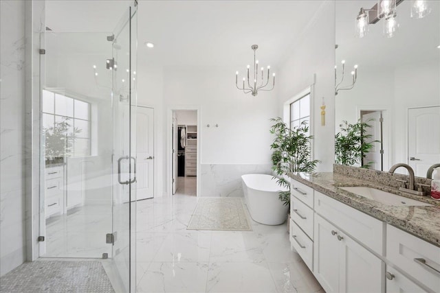 14990 Michelle Ln, Beaumont, TX 77713 - bathroom featuring vanity, a chandelier, a shower stall, a freestanding tub, and marble tiled flooring