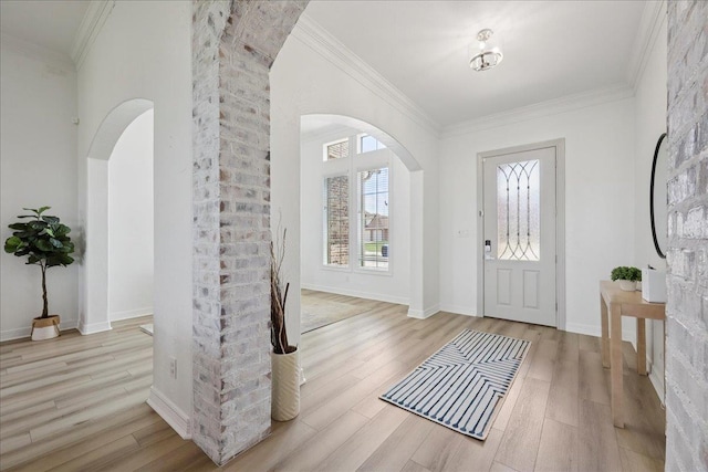 14990 Michelle Ln, Beaumont, TX 77713 - entrance foyer featuring arched walkways, wood finished floors, crown molding, and baseboards
