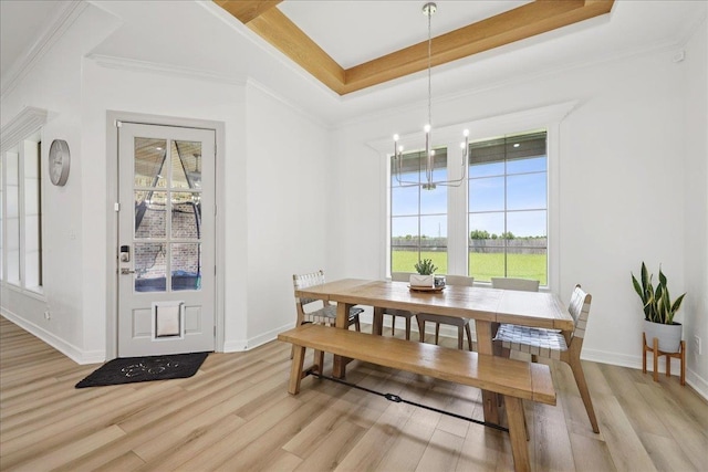 14990 Michelle Ln, Beaumont, TX 77713 - dining room featuring light wood-style floors, plenty of natural light, baseboards, and ornamental molding