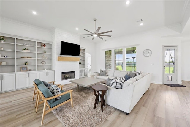 14990 Michelle Ln, Beaumont, TX 77713 - living room featuring ceiling fan, a large fireplace, healthy amount of natural light, recessed lighting, and light wood finished floors