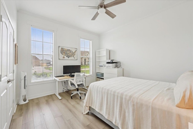 14990 Michelle Ln, Beaumont, TX 77713 - bedroom with light wood-style floors, a desk, baseboards, and a ceiling fan