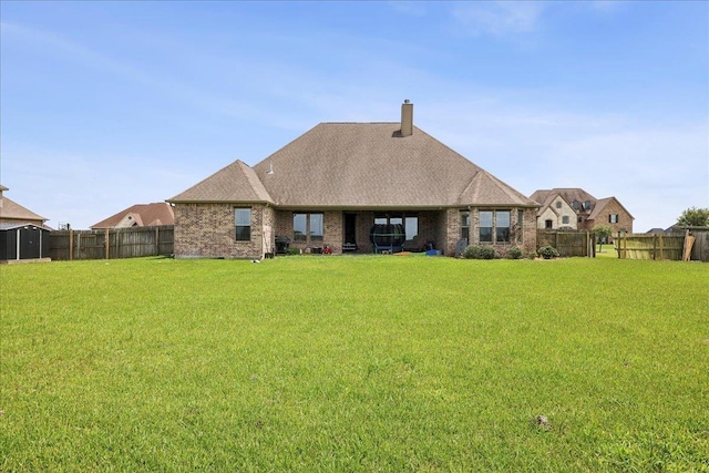 14990 Michelle Ln, Beaumont, TX 77713 - rear view of house with brick siding, a chimney, and a shingled roof