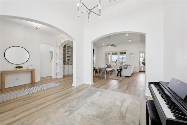 14990 Michelle Ln, Beaumont, TX 77713 - entrance foyer with wood finished floors, crown molding, baseboards, arched walkways, and ceiling fan