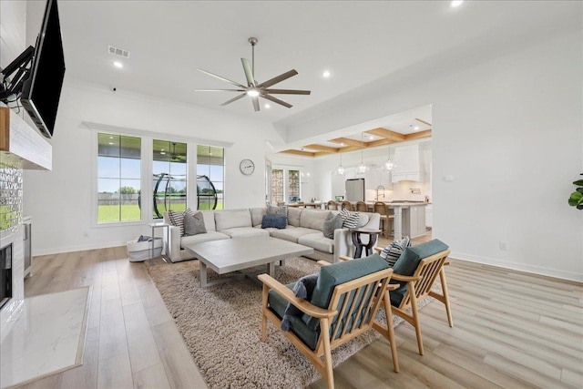 14990 Michelle Ln, Beaumont, TX 77713 - living room featuring ceiling fan, recessed lighting, a fireplace, light wood-type flooring, and baseboards