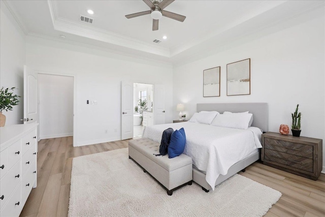14990 Michelle Ln, Beaumont, TX 77713 - bedroom with a tray ceiling, light wood-style flooring, ornamental molding, recessed lighting, and connected bathroom