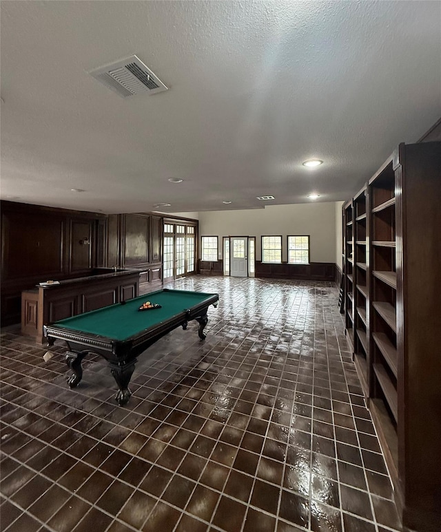 recreation room with a textured ceiling and billiards