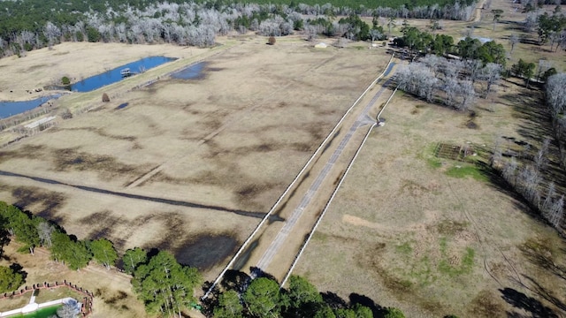 birds eye view of property featuring a water view and a rural view