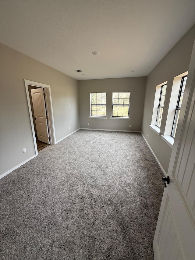 spare room with vaulted ceiling and carpet flooring