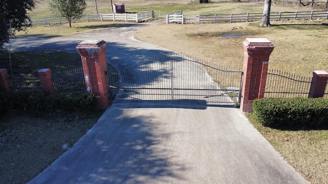 view of gate with a rural view