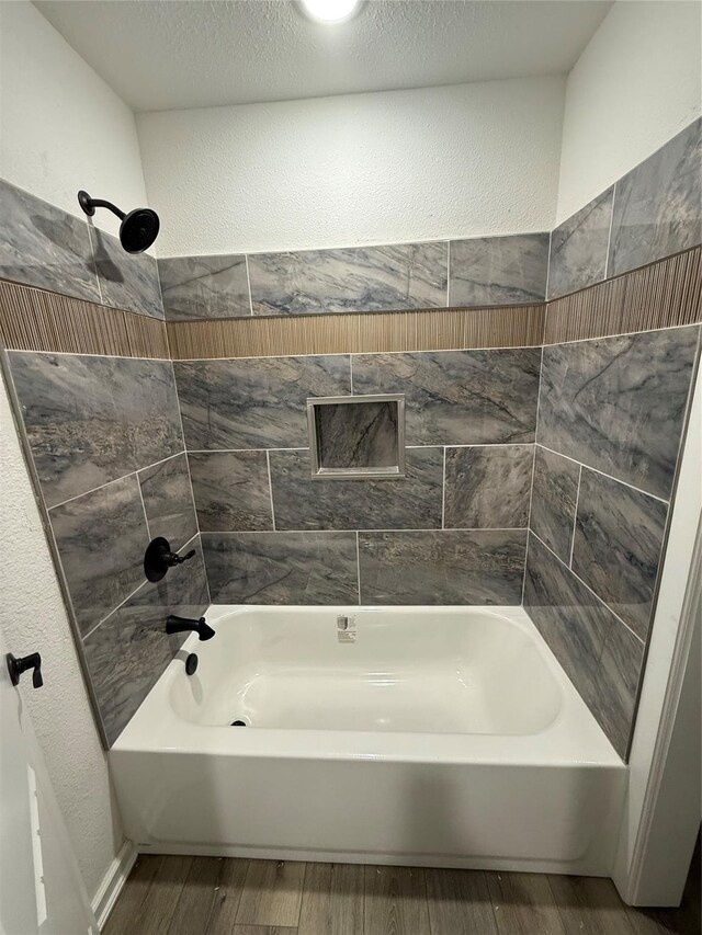 bathroom featuring shower / bathing tub combination and wood-type flooring