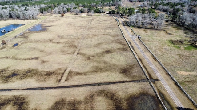 birds eye view of property with a rural view and a water view
